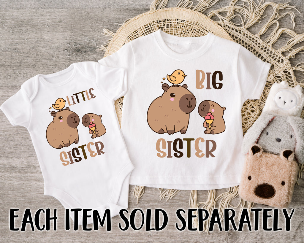 Get trendy with Capybara Big Sister Little Sister T-Shirt Baby Grow Set -  available at DizzyKitten. Grab yours for £9.45 today!