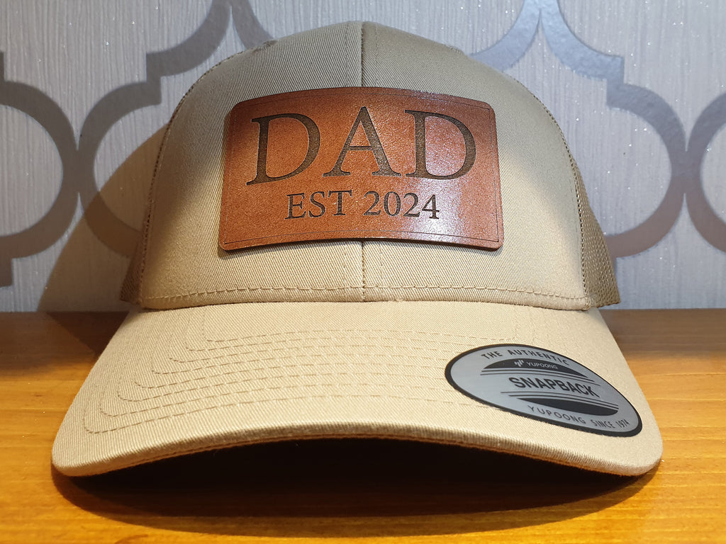 Get trendy with Dad Est 2024 Real Leather Patch Trucker Hat - Hat available at DizzyKitten. Grab yours for £25.99 today!
