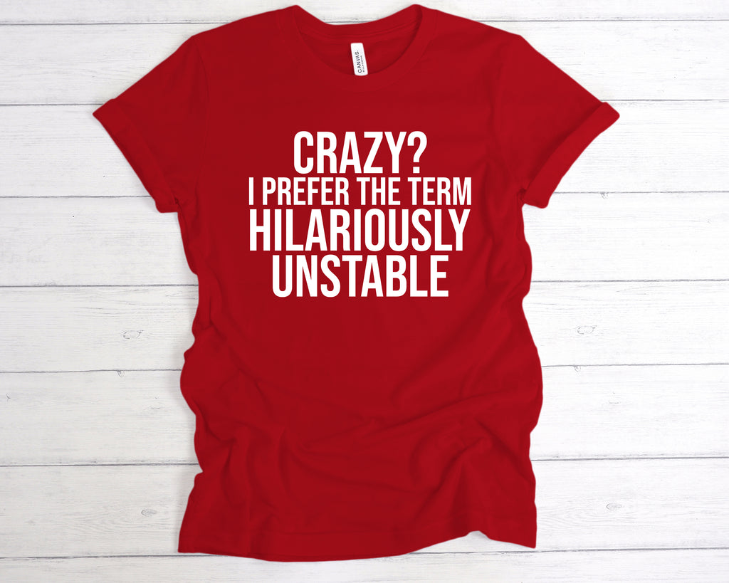 Red unisex t-shirt featuring the funny slogan "Crazy? I Prefer The Term Hilariously Unstable" printed in bold white lettering across the chest. This soft cotton humour shirt is perfect as a sarcastic gift, mental health awareness tee, or light-hearted statement piece. Designed for comfort and style, it’s ideal for anyone who embraces their wild side with pride. A great choice for fans of funny quote t-shirts, chaotic personality apparel, or quirky fashion.