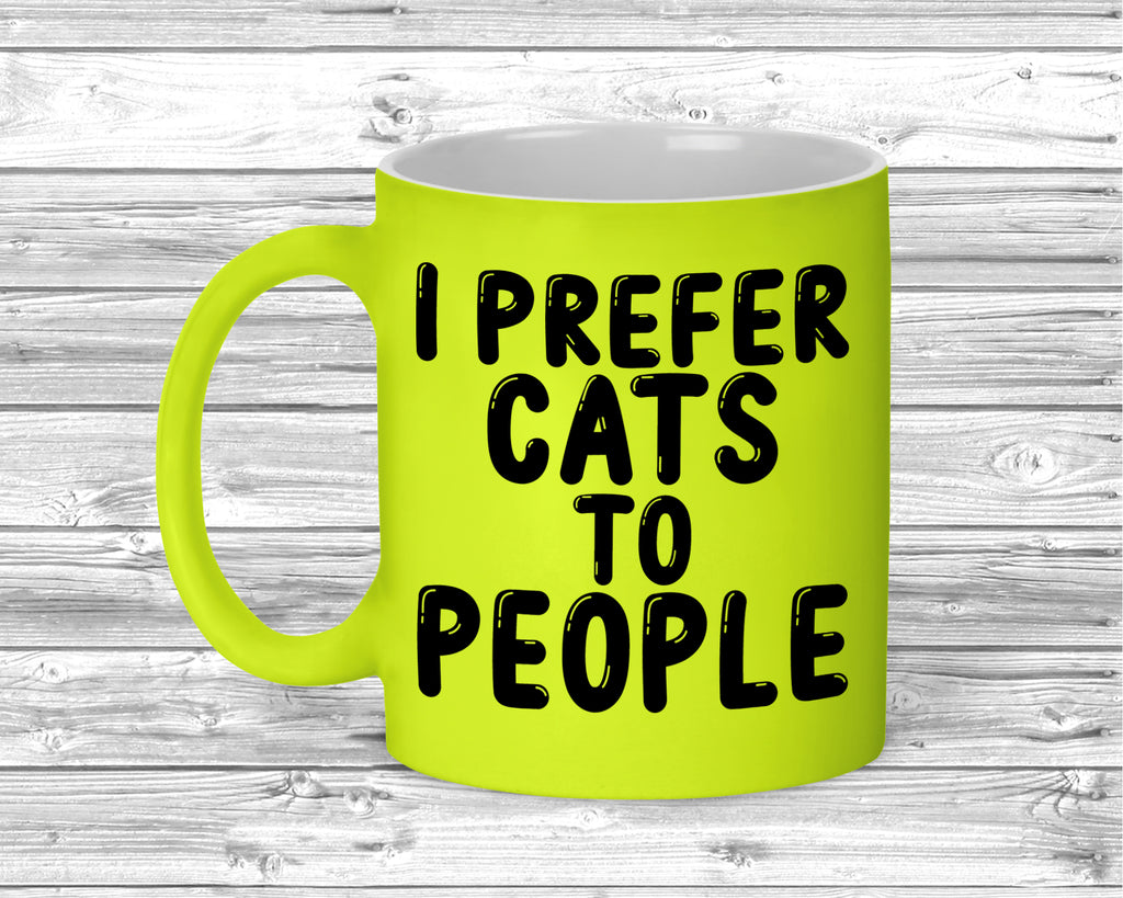 Fluorescent ceramic mug with I Prefer Cats To People slogan printed on front.