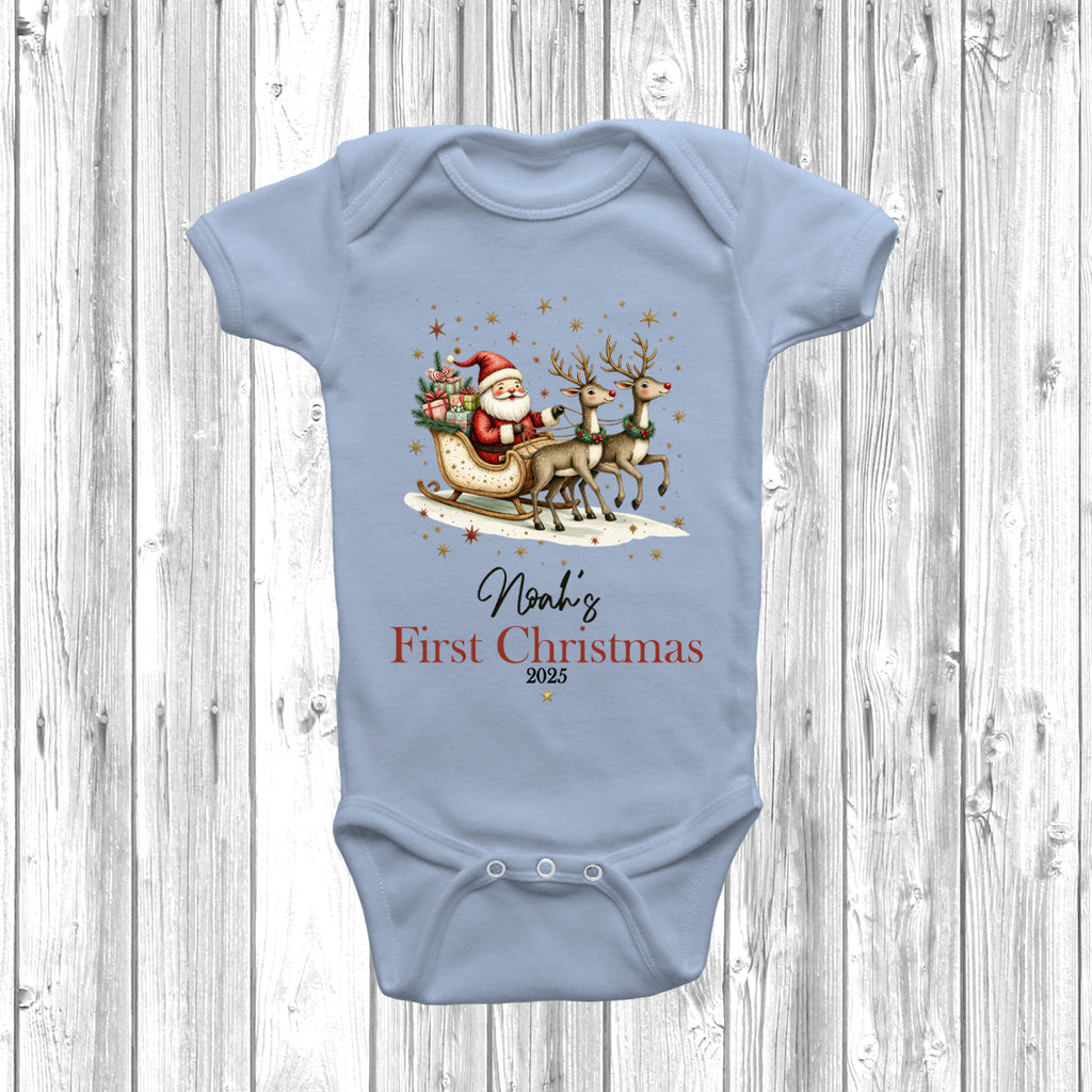 Festive personalised First Christmas baby grow in Pastel Blue, with Santa, reindeer, and snowflake design, ideal for Christmas baby gift.