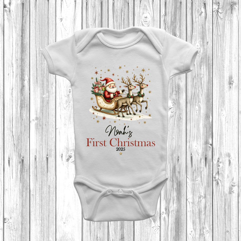 Personalised baby grow with Santa sleigh and reindeer design, featuring baby’s name and First Christmas 2025 printed on soft white cotton.