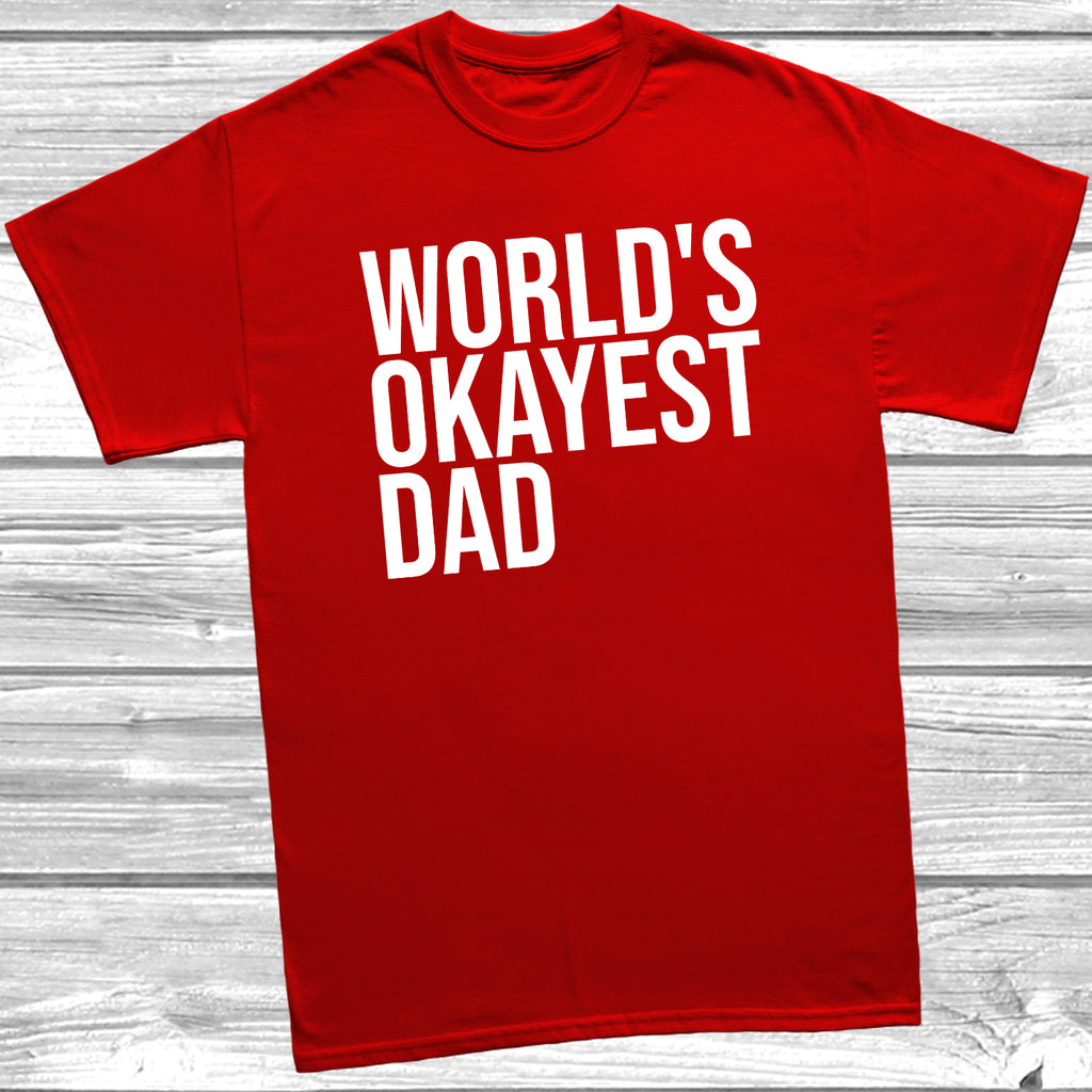 Red Father’s Day T-shirt laid flat with the quote “World’s Okayest Dad,” styled for casual everyday wear.