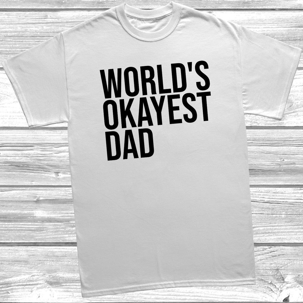 White Father’s Day T-shirt laid flat with the quote “World’s Okayest Dad,” styled for casual everyday wear.